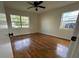 Bedroom features hardwood floors, neutral walls, ample natural light from two windows, and ceiling fan at 766 Bates Sw Ave, Winter Haven, FL 33880