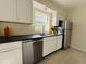 Modern kitchen with stainless steel appliances, bright white cabinets, and sleek black countertops at 766 Bates Sw Ave, Winter Haven, FL 33880