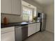 Bright kitchen features stainless steel appliances, stone tile flooring, and modern white cabinets at 766 Bates Sw Ave, Winter Haven, FL 33880