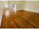 Spacious living room featuring gleaming hardwood floors and ample natural light from the front windows at 766 Bates Sw Ave, Winter Haven, FL 33880