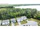 A stunning aerial view showcases a perfectly situated home on a large lot with a nearby lake and wooded surroundings at 29912 Cypress Pointe, Deer Island, FL 32778