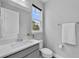 Bathroom featuring a single sink with a white countertop, gray cabinets, a toilet and a towel rack at 29912 Cypress Pointe, Deer Island, FL 32778