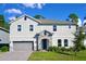 Charming two-story home boasts a stone entryway, inviting curb appeal, and a well-manicured lawn at 29912 Cypress Pointe, Deer Island, FL 32778