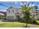 Beautiful home featuring stone accents, a well-manicured lawn, and a two-car garage in a desirable neighborhood at 29912 Cypress Pointe, Deer Island, FL 32778