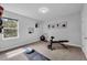 Bright, carpeted home gym with a window, yoga mat, bench and other fitness equipment and neutral wall art at 29912 Cypress Pointe, Deer Island, FL 32778