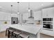 Modern kitchen boasts a large center island, stainless steel appliances, and sleek white cabinets for a contemporary look at 29912 Cypress Pointe, Deer Island, FL 32778