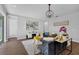 Inviting living room featuring stylish decor, wood floors, modern light fixture and an open concept design at 29912 Cypress Pointe, Deer Island, FL 32778