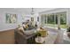 Bright and airy living room with comfortable seating, a view of the backyard, and an open connection to the kitchen at 29912 Cypress Pointe, Deer Island, FL 32778