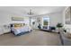 The main bedroom features a cozy sitting area and a chandelier creating an inviting retreat at 29912 Cypress Pointe, Deer Island, FL 32778