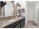 Elegant bathroom featuring a double vanity with granite countertops and modern fixtures at 1548 Astoria Arbor Ln, Orlando, FL 32824