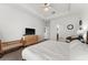 Well-lit bedroom showcasing a TV, dresser, and modern decor at 1548 Astoria Arbor Ln, Orlando, FL 32824