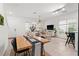 Bright dining area flows into living space, featuring modern decor and natural light at 1548 Astoria Arbor Ln, Orlando, FL 32824