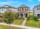 Charming two-story home with landscaped yard and a welcoming front porch at 1548 Astoria Arbor Ln, Orlando, FL 32824