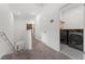 Upstairs hallway leads to a laundry room with stacked machines and storage at 1548 Astoria Arbor Ln, Orlando, FL 32824