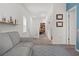 Upstairs hallway featuring neutral carpet, white walls, and entry into rooms at 1548 Astoria Arbor Ln, Orlando, FL 32824