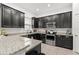 Well-equipped kitchen with granite countertops, stainless steel appliances, and sleek black cabinetry at 1548 Astoria Arbor Ln, Orlando, FL 32824