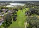 Aerial view of golf course and homes bordering a lake at 611 Nuevo Leon Ln, The Villages, FL 32159