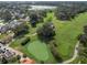 Aerial view of golf course with lush green fairways and homes at 611 Nuevo Leon Ln, The Villages, FL 32159