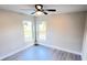 A quiet bedroom with natural light is enhanced by neutral walls and flooring with two windows at 2469 Courtland Blvd, Deltona, FL 32738