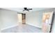 A large bedroom has a sliding barn door and a view into the spacious kitchen at 2469 Courtland Blvd, Deltona, FL 32738