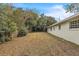 Large backyard with mature trees and a wooden fence at 1228 Se 17Th St, Ocala, FL 34471