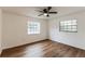 Bright bedroom with ceiling fan and wood-look floors at 1228 Se 17Th St, Ocala, FL 34471