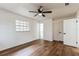 Bright bedroom with wood-look floors, ceiling fan, and ample closet space at 1228 Se 17Th St, Ocala, FL 34471