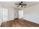 Spacious bedroom with wood-look floors, access to bathroom, and large closet at 1228 Se 17Th St, Ocala, FL 34471