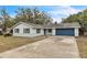 Newly renovated home with blue garage door and landscaped yard at 1228 Se 17Th St, Ocala, FL 34471