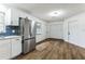 Modern kitchen with white cabinets, stainless steel appliances, and blue tile backsplash at 1228 Se 17Th St, Ocala, FL 34471