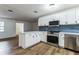 Modern kitchen with white cabinets, stainless steel appliances, and blue tile backsplash at 1228 Se 17Th St, Ocala, FL 34471