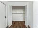 White storage room with built-in shelves and wood-look floors at 1228 Se 17Th St, Ocala, FL 34471