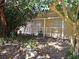 Exterior of the home with a small covered area featuring neutral paint and natural landscaping at 1505 N Peninsula Ave, New Smyrna Beach, FL 32169