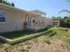 Home backyard with small raised deck, and neutral-painted exterior at 1505 N Peninsula Ave, New Smyrna Beach, FL 32169