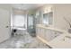 Elegant bathroom with a soaking tub, walk-in shower, and marble floors at 2621 Lookout, Kissimmee, FL 34746