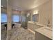 Luxurious bathroom with a soaking tub, walk-in shower, and marble floors at 2621 Lookout, Kissimmee, FL 34746