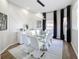 Modern dining room featuring a glass table and white chairs at 2621 Lookout, Kissimmee, FL 34746