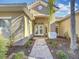 Elegant entryway with double doors, a stone pathway, and lush landscaping at 2621 Lookout, Kissimmee, FL 34746