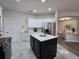 Island kitchen features white cabinets and marble flooring at 2621 Lookout, Kissimmee, FL 34746