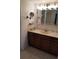 Well-lit bathroom vanity features a large mirror, lots of storage, and a neutral color palette at 2923 Antique Oaks Cir # 37, Winter Park, FL 32792