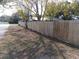 Side yard with wooden fence and grassy area at 504 Shiloh St, Fruitland Park, FL 34731