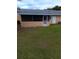 Exterior view of the screened patio and backyard at 3110 Port Royal Dr, Orlando, FL 32827