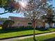 Charming home with manicured lawn, mature trees, and a 'For Sale' sign at 3110 Port Royal Dr, Orlando, FL 32827