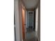 Hallway featuring open doors and a built-in shelving unit for convenient storage at 3110 Port Royal Dr, Orlando, FL 32827