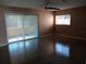 Bright living room featuring polished floors, neutral walls, and natural light from sliding glass doors at 3110 Port Royal Dr, Orlando, FL 32827