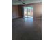 Spacious living room with terrazzo floors and sliding door to the lanai at 3110 Port Royal Dr, Orlando, FL 32827