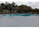 Community pool with surrounding concrete area and black metal fencing to provide privacy and a relaxing atmosphere at 3110 Port Royal Dr, Orlando, FL 32827