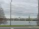 Scenic view of a bridge stretching over the water with buildings visible in the distance on a cloudy day at 4200 Lake Underhill Rd # A, Orlando, FL 32803