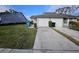 Front view of a gray house with a two-car garage and well-maintained lawn at 4520 Summergrove Ave, Orlando, FL 32812