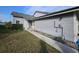 Side view of a gray house with walkway leading to the entrance at 4520 Summergrove Ave, Orlando, FL 32812